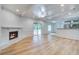 Bright living room with fireplace and ceiling fan; open to kitchen with wood floors at 19 Milano Ct, Hanahan, SC 29410