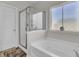 Bright bathroom with a soaking tub, glass shower, and decorative window at 192 Weeping Cypress Dr, Moncks Corner, SC 29461