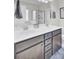 Bathroom featuring a double sink vanity with dark wood cabinets, large mirror, and a walk in shower at 192 Weeping Cypress Dr, Moncks Corner, SC 29461