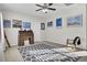 Spacious bedroom with a ceiling fan, vintage desk and chair, and gray patterned rug at 192 Weeping Cypress Dr, Moncks Corner, SC 29461