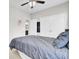 Bright bedroom featuring a ceiling fan, a closet with mirrored doors, and a large window at 192 Weeping Cypress Dr, Moncks Corner, SC 29461