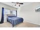 Bright bedroom featuring a ceiling fan, a closet with mirrored doors, and a large window at 192 Weeping Cypress Dr, Moncks Corner, SC 29461