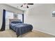 Bright bedroom featuring a ceiling fan, a closet with mirrored doors, and a large window at 192 Weeping Cypress Dr, Moncks Corner, SC 29461
