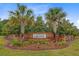 Attractive brick entrance to Cypress Grove with Palm Trees and manicured landscaping at 192 Weeping Cypress Dr, Moncks Corner, SC 29461