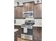 Kitchen with stainless steel appliances and dark cabinets at 192 Weeping Cypress Dr, Moncks Corner, SC 29461