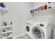 Bright laundry room featuring a modern washer and dryer, complemented by organized shelving and storage solutions at 192 Weeping Cypress Dr, Moncks Corner, SC 29461