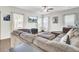 Comfortable living room featuring a large sectional sofa, TV, ceiling fan and lots of natural light at 192 Weeping Cypress Dr, Moncks Corner, SC 29461