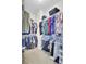 Spacious walk-in closet with ample hanging storage on multiple rods, perfect for organizing clothes and accessories at 192 Weeping Cypress Dr, Moncks Corner, SC 29461