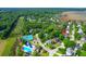 This gorgeous aerial view showcases the swimming pool, tennis courts, and mature trees in this Gathering friendly neighborhood at 200 Oak Point Landing Dr, Mount Pleasant, SC 29464