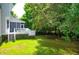 Backyard features a screened in porch, deck, lush lawn and mature trees at 200 Oak Point Landing Dr, Mount Pleasant, SC 29464