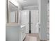 Fresh bathroom showcasing a blue palette, modern vanity, and linen closet at 200 Oak Point Landing Dr, Mount Pleasant, SC 29464