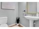 Cozy powder room featuring a pedestal sink and stylish decor at 200 Oak Point Landing Dr, Mount Pleasant, SC 29464