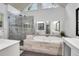 Bright bathroom featuring a walk-in shower, soaking tub, double vanity, and natural light from a triangular window at 200 Oak Point Landing Dr, Mount Pleasant, SC 29464