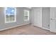 Bedroom displaying two windows, light-colored walls, and a spacious closet at 200 Oak Point Landing Dr, Mount Pleasant, SC 29464
