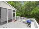 Back deck features a screened-in porch, bench seating, a white railing and grill at 200 Oak Point Landing Dr, Mount Pleasant, SC 29464