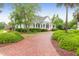 Charming single-story home features a brick walkway, manicured landscaping, and a covered front porch at 200 Oak Point Landing Dr, Mount Pleasant, SC 29464