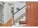 Welcoming foyer featuring hardwood floors and a staircase with white railings at 200 Oak Point Landing Dr, Mount Pleasant, SC 29464