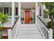 Inviting front porch with a vibrant orange door and elegant white columns at 200 Oak Point Landing Dr, Mount Pleasant, SC 29464