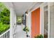 Covered front porch featuring a charming orange door and classic black accents at 200 Oak Point Landing Dr, Mount Pleasant, SC 29464
