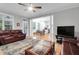 Comfortable living room with fireplace open to kitchen and access to the back deck at 200 Oak Point Landing Dr, Mount Pleasant, SC 29464