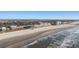 Scenic aerial view showcasing a beachfront condo next to a white sandy beach and clear blue ocean waters at 201 W Arctic Ave # 406, Folly Beach, SC 29439