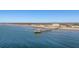 Panoramic aerial view of beachfront condos, a pier and ocean, a vibrant coastal scene at 201 W Arctic Ave # 406, Folly Beach, SC 29439