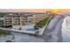 Aerial view of beachfront complex featuring a pool, well-manicured grounds, and ocean access at 201 W Arctic Ave # 406, Folly Beach, SC 29439