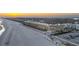 Stunning aerial view of beachfront condo with pool access and a tranquil beach at sunset, perfect for relaxation at 201 W Arctic Ave # 406, Folly Beach, SC 29439