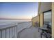 Relaxing balcony with seating and a stunning view of the beach at dusk at 201 W Arctic Ave # 406, Folly Beach, SC 29439