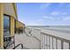Inviting balcony with seating area overlooking the beach and a view of the pier at 201 W Arctic Ave # 406, Folly Beach, SC 29439