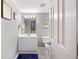 Well-lit bathroom with white vanity, mirror, toilet, and a glimpse into the bedroom at 201 W Arctic Ave # 406, Folly Beach, SC 29439