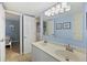 Inviting bathroom with a double sink vanity and an open door to a bedroom at 201 W Arctic Ave # 406, Folly Beach, SC 29439