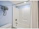 Bathroom includes a white shower and decorative bicycle wall art at 201 W Arctic Ave # 406, Folly Beach, SC 29439