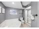 Bathroom features a combination tub and shower with gray walls and beach-themed decor at 201 W Arctic Ave # 406, Folly Beach, SC 29439
