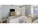 Bedroom with a queen bed, a TV, and access to a bathroom at 201 W Arctic Ave # 406, Folly Beach, SC 29439