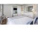 Bright bedroom features a queen bed, dresser, and sliding closet doors at 201 W Arctic Ave # 406, Folly Beach, SC 29439
