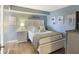 Comfortable bedroom with a queen bed, a TV, and beach-themed wall art at 201 W Arctic Ave # 406, Folly Beach, SC 29439