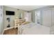 Comfortable bedroom with a dresser, mirror, and a glimpse into the bathroom and a spacious closet at 201 W Arctic Ave # 406, Folly Beach, SC 29439