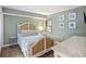 Cozy bedroom features a stylish rattan bed frame, light green walls, and beach-themed decor at 201 W Arctic Ave # 406, Folly Beach, SC 29439