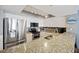 Modern kitchen with stainless steel appliances, granite countertops, and ample cabinet space at 201 W Arctic Ave # 406, Folly Beach, SC 29439