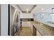 Spacious kitchen with granite countertops, stainless steel appliances and ample cabinet space at 201 W Arctic Ave # 406, Folly Beach, SC 29439