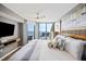Bright main bedroom boasts ocean views, balcony access, ceiling fan, and comfortable king bed at 201 W Arctic Ave # 406, Folly Beach, SC 29439