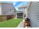 Backyard showing the screened-in porch, grassy lawn, grilling space, and fencing at 2025 Maybelles Ln, Charleston, SC 29414