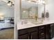 Bathroom featuring a double sink vanity and a view into the primary bedroom at 2025 Maybelles Ln, Charleston, SC 29414