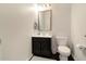 Neutral bathroom with a modern vanity, decorative mirror, and updated fixtures, creating a clean and inviting space at 2025 Maybelles Ln, Charleston, SC 29414