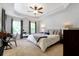 Primary bedroom features a ceiling fan, trey ceiling, two windows, and a desk at 2025 Maybelles Ln, Charleston, SC 29414