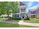 Inviting two-story home with a cozy front porch swing and well-manicured lawn at 2025 Maybelles Ln, Charleston, SC 29414