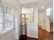 Bright and airy foyer with hardwood floors and natural light streaming through the door at 2025 Maybelles Ln, Charleston, SC 29414