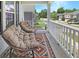 Front porch featuring two chairs, an outdoor rug, and views of the neighborhood at 2025 Maybelles Ln, Charleston, SC 29414