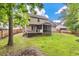 The backyard features a deck and screened porch, complemented by lush green lawn, and a privacy fence at 206 Hawkridge Pl, Goose Creek, SC 29445